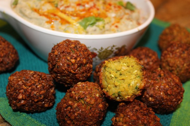 Falafels, tinted with a hint of turmeric and flecked with green parsley